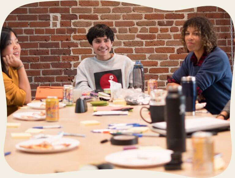 students-in-conference-room-eating-lunch-and-discussing-nod-research-and-design